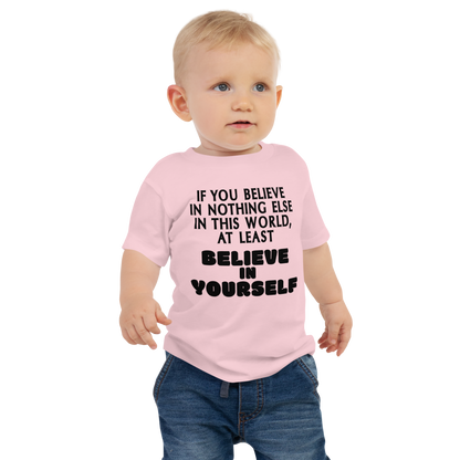 "If you believe in nothing else in this world, at least believe in yourself" printed on a pink baby jersey short sleeve tee worn by a male