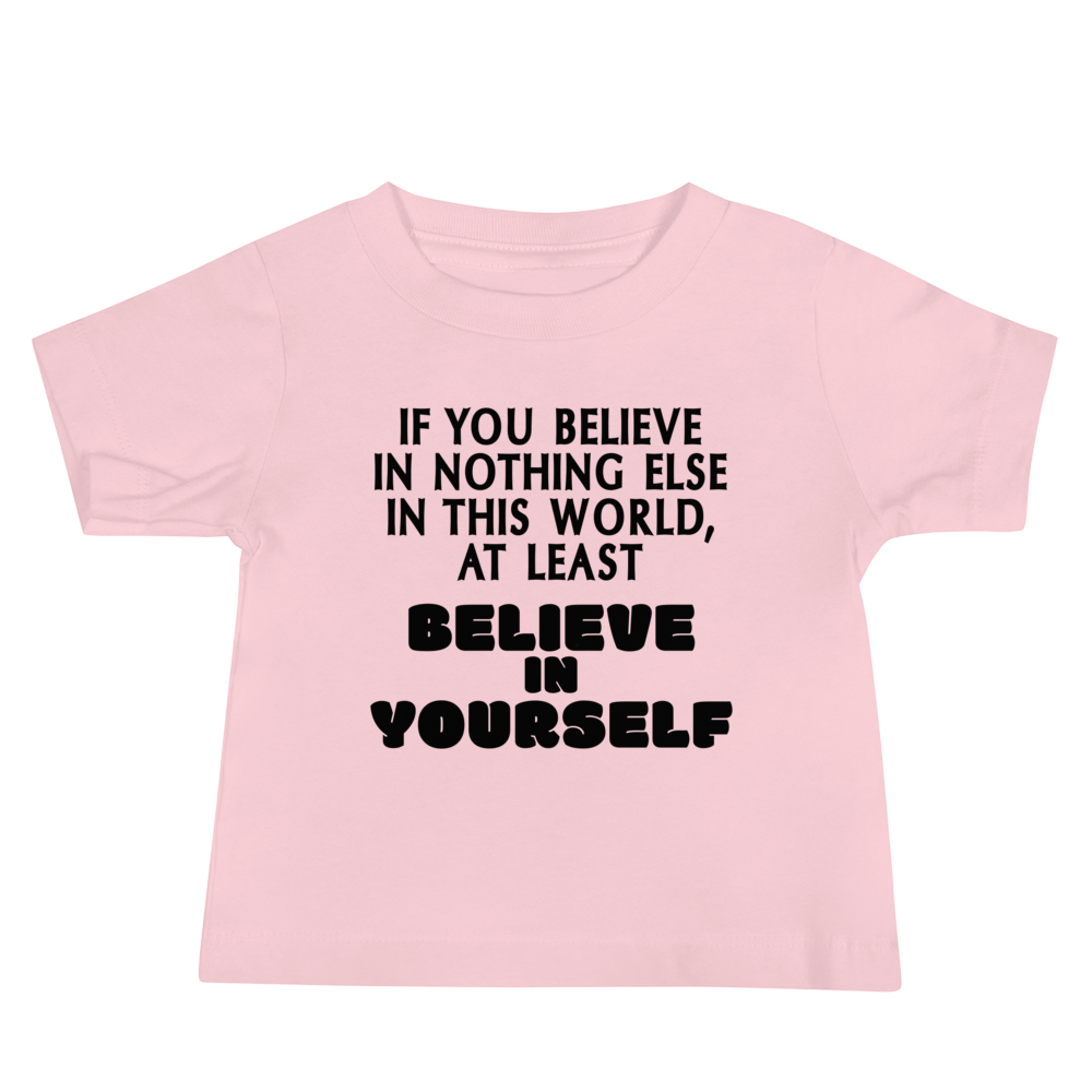 "If you believe in nothing else in this world, at least believe in yourself" printed on a pink baby jersey short sleeve tee laying on a flat surface