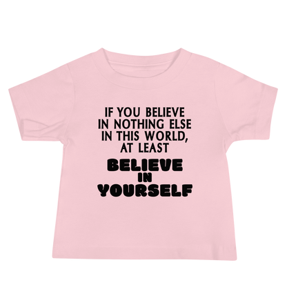 "If you believe in nothing else in this world, at least believe in yourself" printed on a pink baby jersey short sleeve tee laying on a flat surface