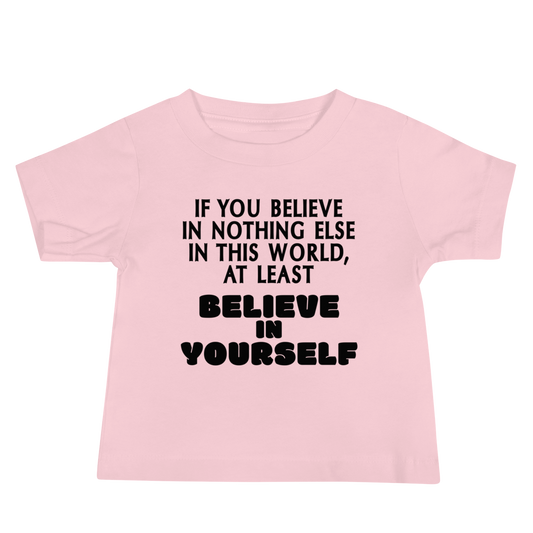 "If you believe in nothing else in this world, at least believe in yourself" printed on a pink baby jersey short sleeve tee laying on a flat surface