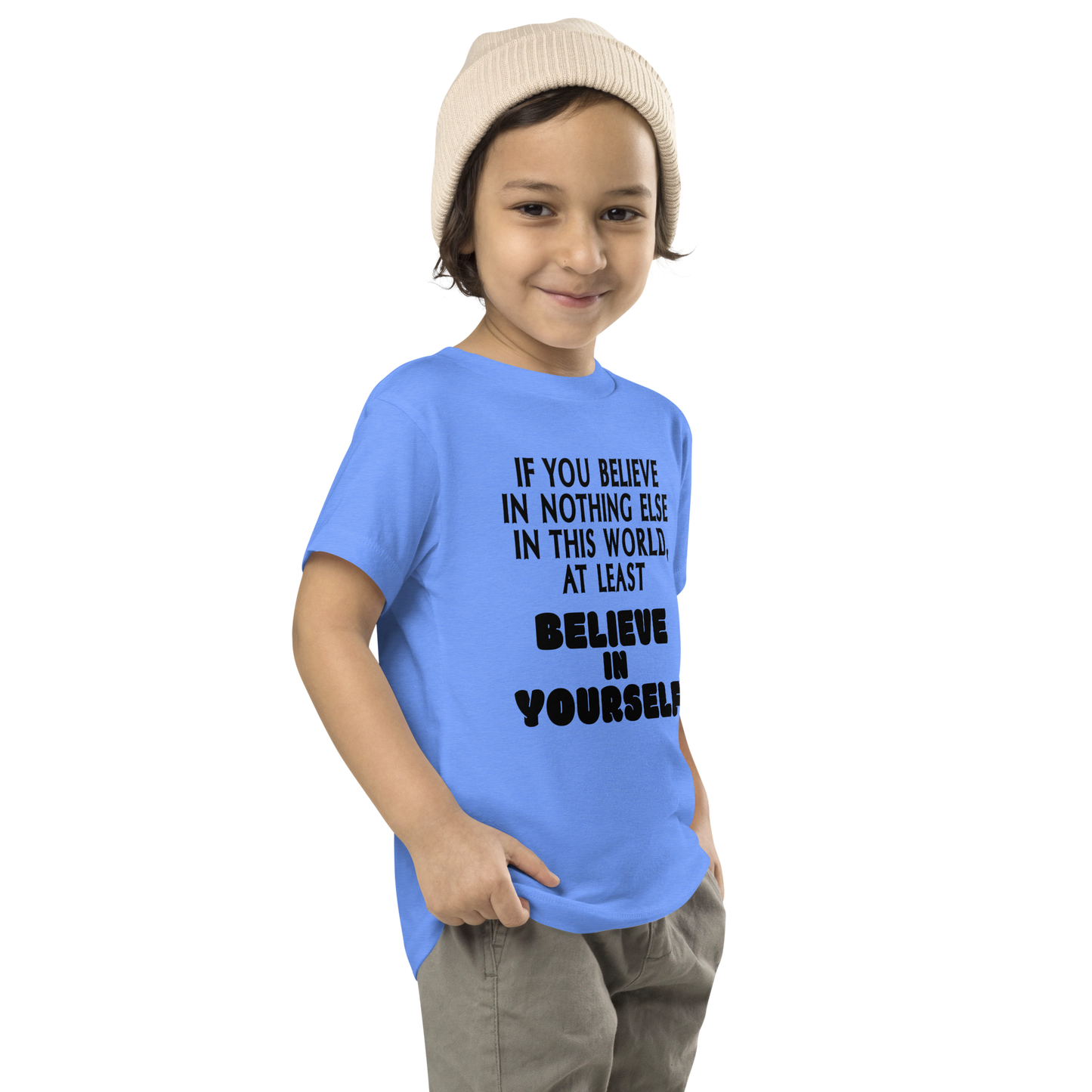 "If you believe in nothing else in this world, at least believe in yourself" printed on a heather columbia blue toddler short sleeve tee worn by a male who is also wearing a knit cap