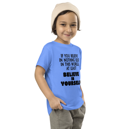 "If you believe in nothing else in this world, at least believe in yourself" printed on a heather columbia blue toddler short sleeve tee worn by a male who is also wearing a knit cap