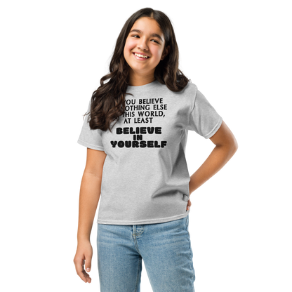 "If you believe in nothing else in this world, at least believe in yourself" printed on a sport grey youth classic tee worn by a female