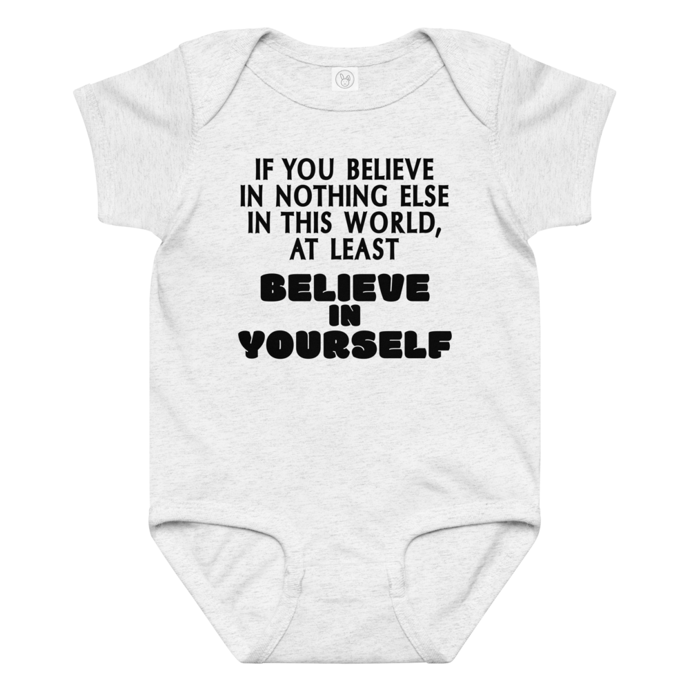 "If you believe in nothing else in this world, at least believe in yourself" printed on a ash baby jersey bodysuit laying on a flat surface amongst other clothes