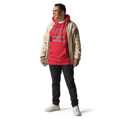 "If you believe in nothing else in this world, at least believe in yourself" printed on a team red unisex hoodie worn by a male with a jacket on top