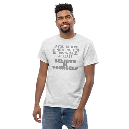 "If you believe in nothing else in this world, at least believe in yourself" printed on a ash unisex classic tee worn by a male