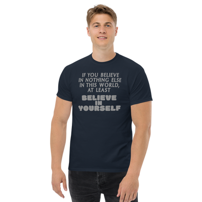 "If you believe in nothing else in this world, at least believe in yourself" printed on a navy unisex classic tee worn by a male