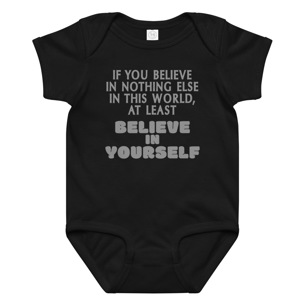 "If you believe in nothing else in this world, at least believe in yourself" printed on a black baby jersey bodysuit laying on a flat surface amongst other clothes