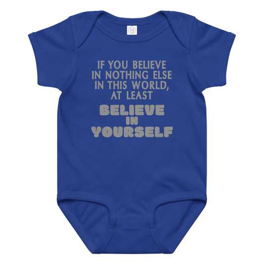 "If you believe in nothing else in this world, at least believe in yourself" printed on a royal baby jersey bodysuit laying on a flat surface amongst other clothes