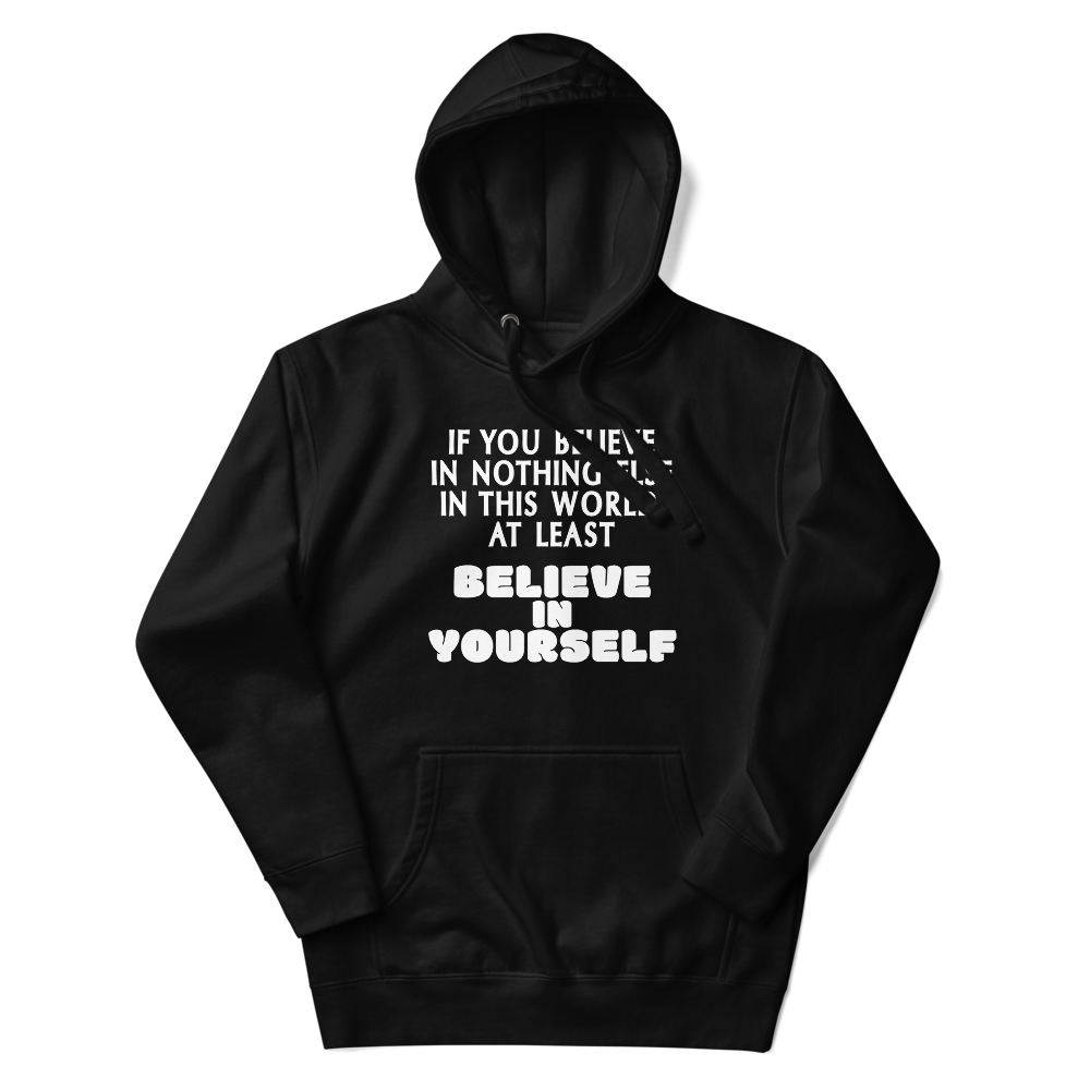 "If you believe in nothing else in this world, at least believe in yourself" printed on a black unisex hoodie laying on a flat surface with the hood up