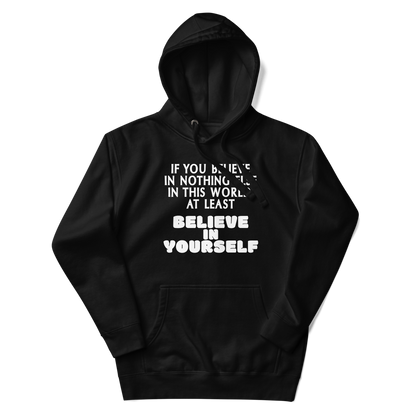 "If you believe in nothing else in this world, at least believe in yourself" printed on a black unisex hoodie laying on a flat surface with the hood up
