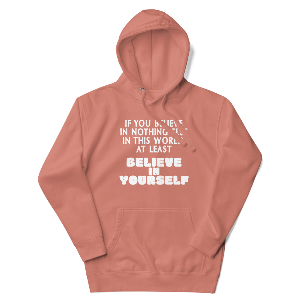 "If you believe in nothing else in this world, at least believe in yourself" printed on a dusty rose unisex hoodie laying on a flat surface with the hood up