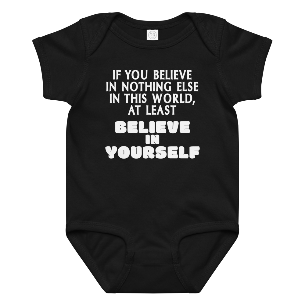 "If you believe in nothing else in this world, at least believe in yourself" printed on a black baby jersey bodysuit laying on a flat surface amongst other clothes
