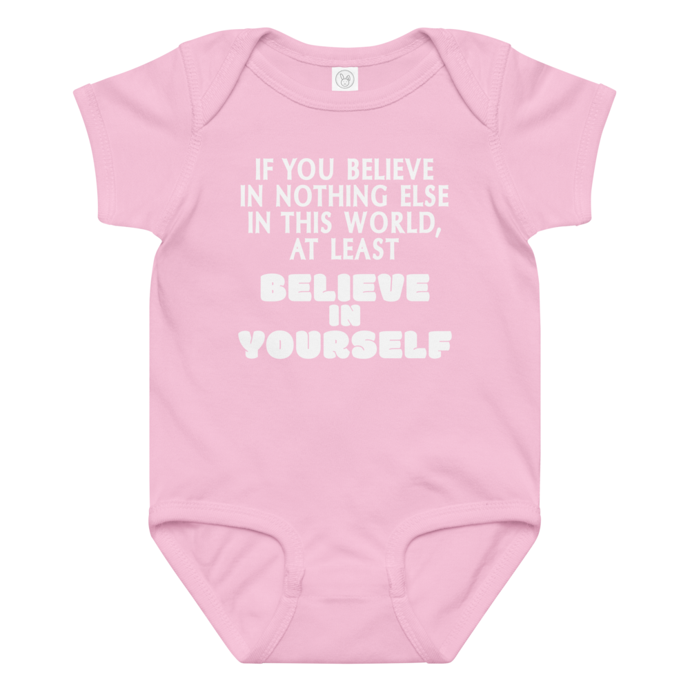 "If you believe in nothing else in this world, at least believe in yourself" printed on a pink baby jersey bodysuit laying on a flat surface amongst other clothes