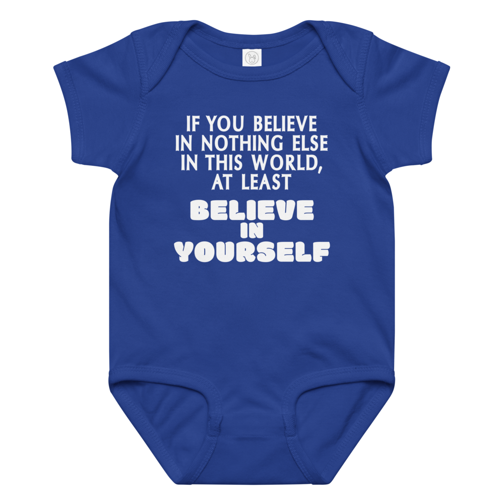 "If you believe in nothing else in this world, at least believe in yourself" printed on a royal baby jersey bodysuit laying on a flat surface amongst other clothes