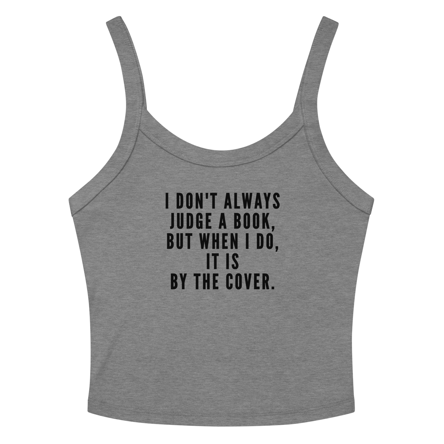 "I Don't always Judge a Book, but when I do, it's by the cover." printed on a athletic heather women's micro-rib tanktop laying on a flat surface amongst sunglasses and shorts