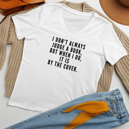 "I Don't always Judge a Book, but when I do, it's by the cover." printed on a solid white blend women's relaxed v-neck t-shirt laying on a flat surface amongst other clothes