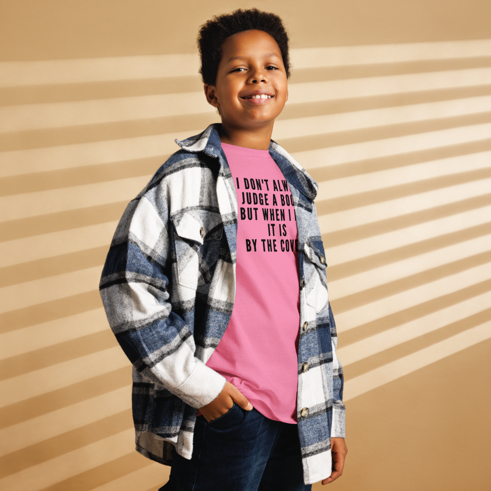"I Don't always Judge a Book, but when I do, it's by the cover." printed on a azalea youth classic tee worn by a male also wearing a jacket