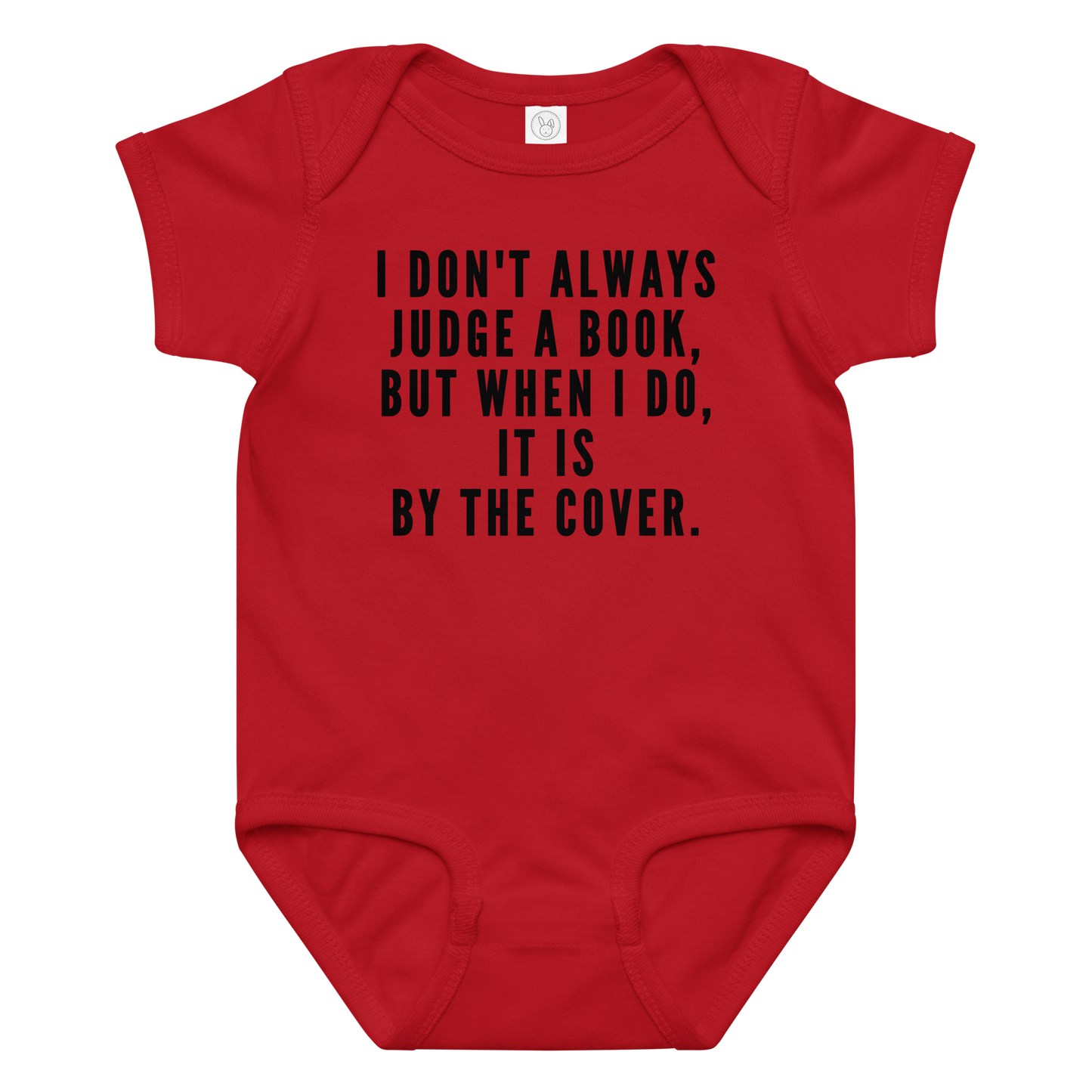 "I Don't always Judge a Book, but when I do, it's by the cover." printed on a red baby jersey bodysuit laying on a flat surface amongst other clothes