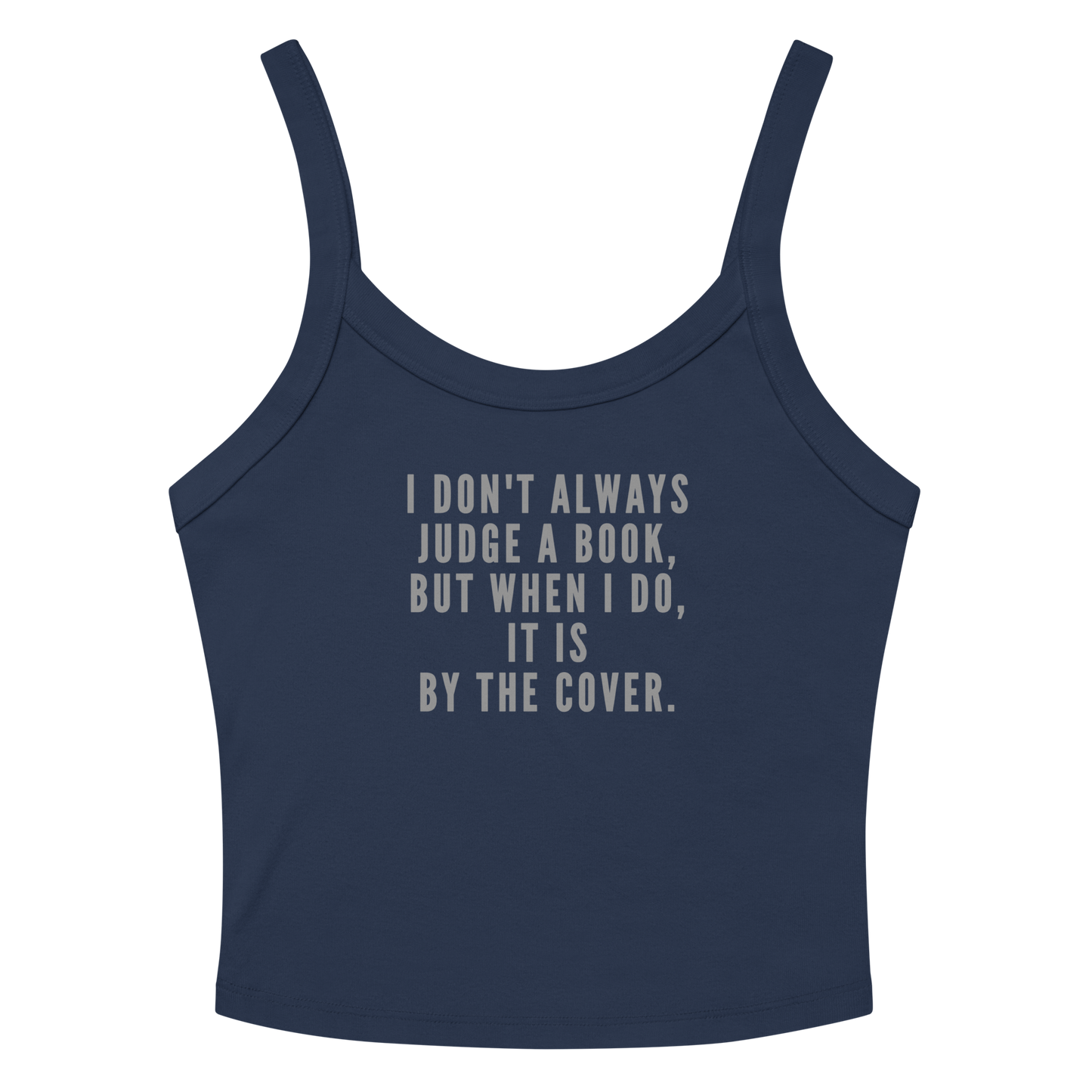 "I Don't always Judge a Book, but when I do, it's by the cover." printed on a solid navy blend women's micro-rib tanktop laying on a flat surface amongst sunglasses and shorts