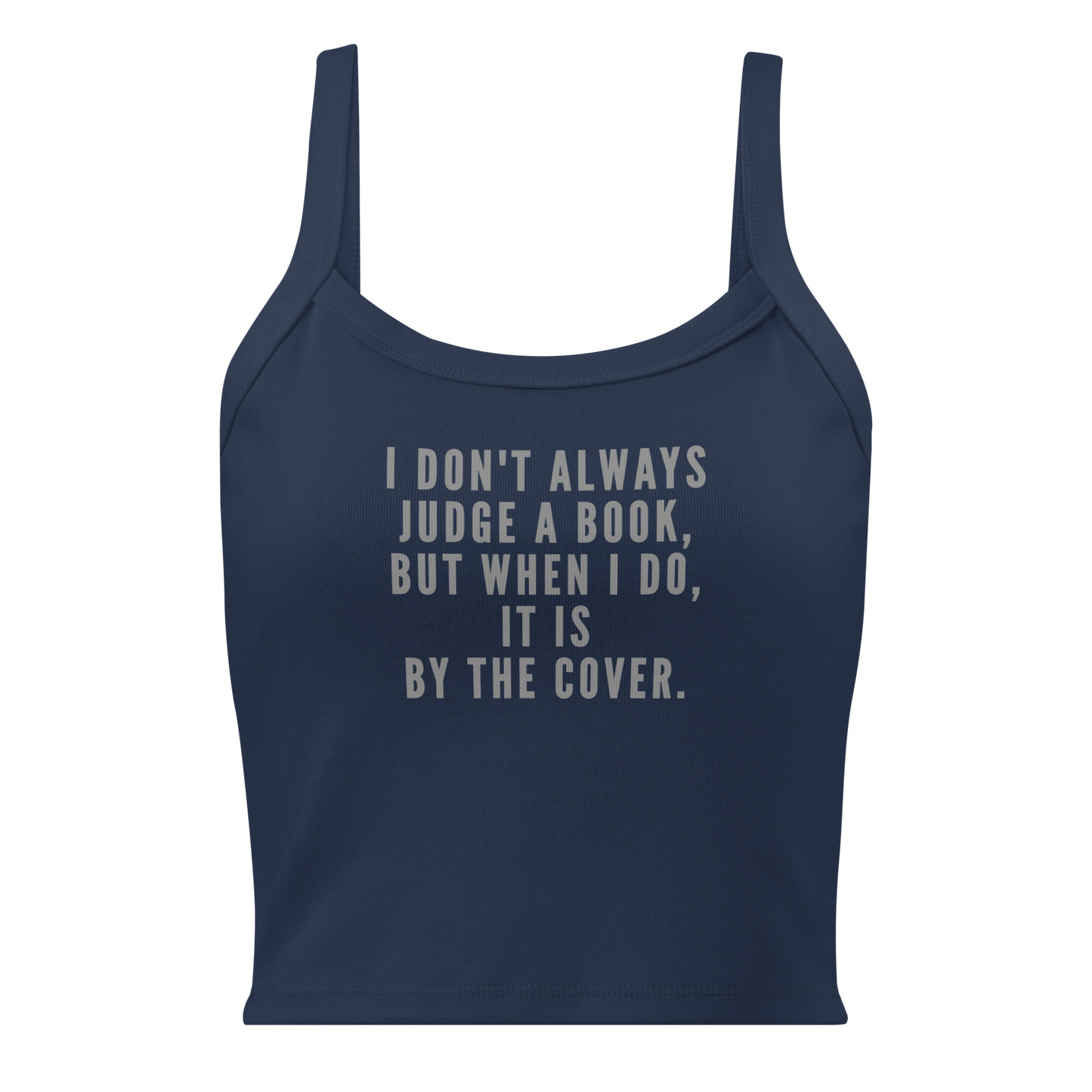 "I Don't always Judge a Book, but when I do, it's by the cover." printed on a solid navy blend women's micro-rib tanktop laying on a flat surface