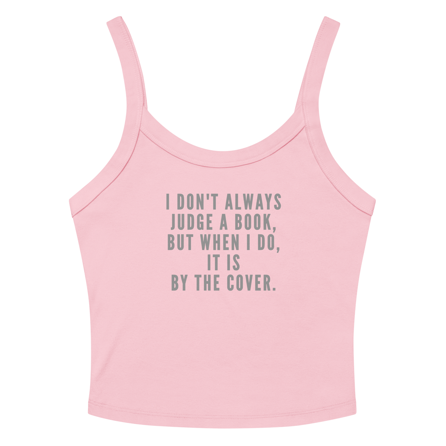 "I Don't always Judge a Book, but when I do, it's by the cover." printed on a solid pink blend women's micro-rib tanktop laying on a flat surface amongst sunglasses and shorts