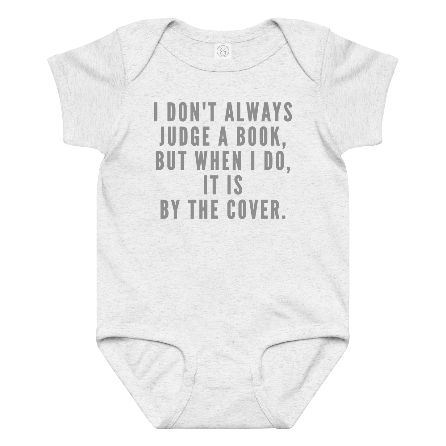 "I Don't always Judge a Book, but when I do, it's by the cover." printed on a ash baby jersey bodysuit laying on a flat surface amongst other clothes
