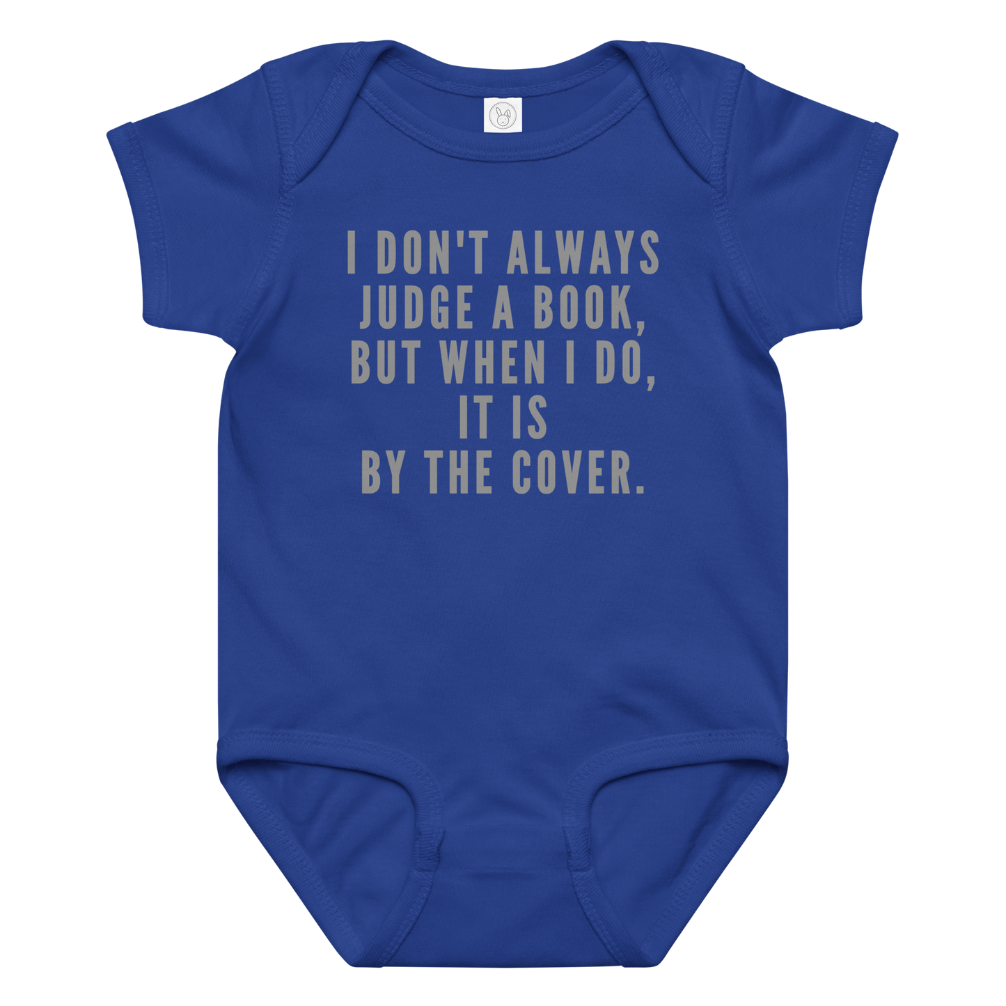 "I Don't always Judge a Book, but when I do, it's by the cover." printed on a royal baby jersey bodysuit laying on a flat surface amongst other clothes