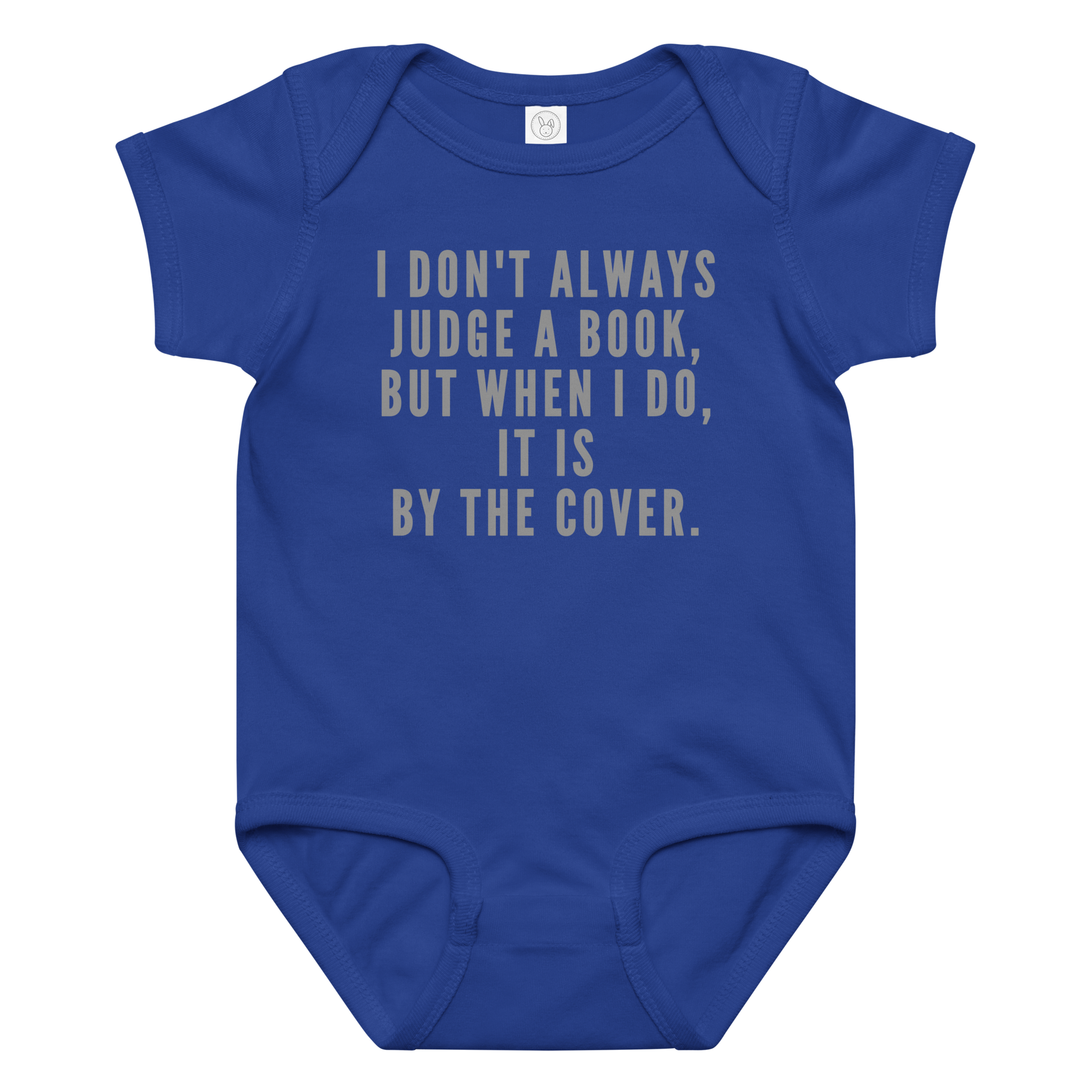 "I Don't always Judge a Book, but when I do, it's by the cover." printed on a royal baby jersey bodysuit laying on a flat surface amongst other clothes