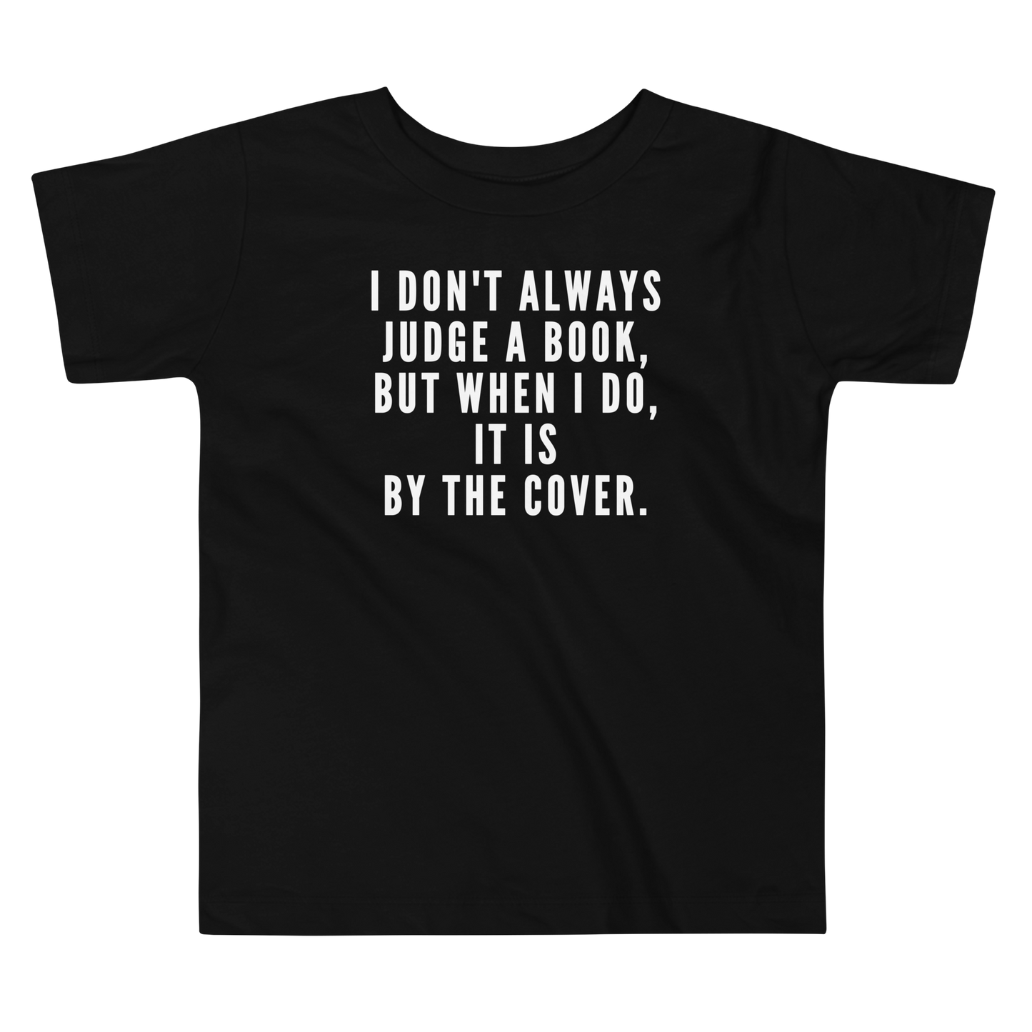 "I Don't always Judge a Book, but when I do, it's by the cover." printed on a black toddler short sleeve tee laying on a flat surface