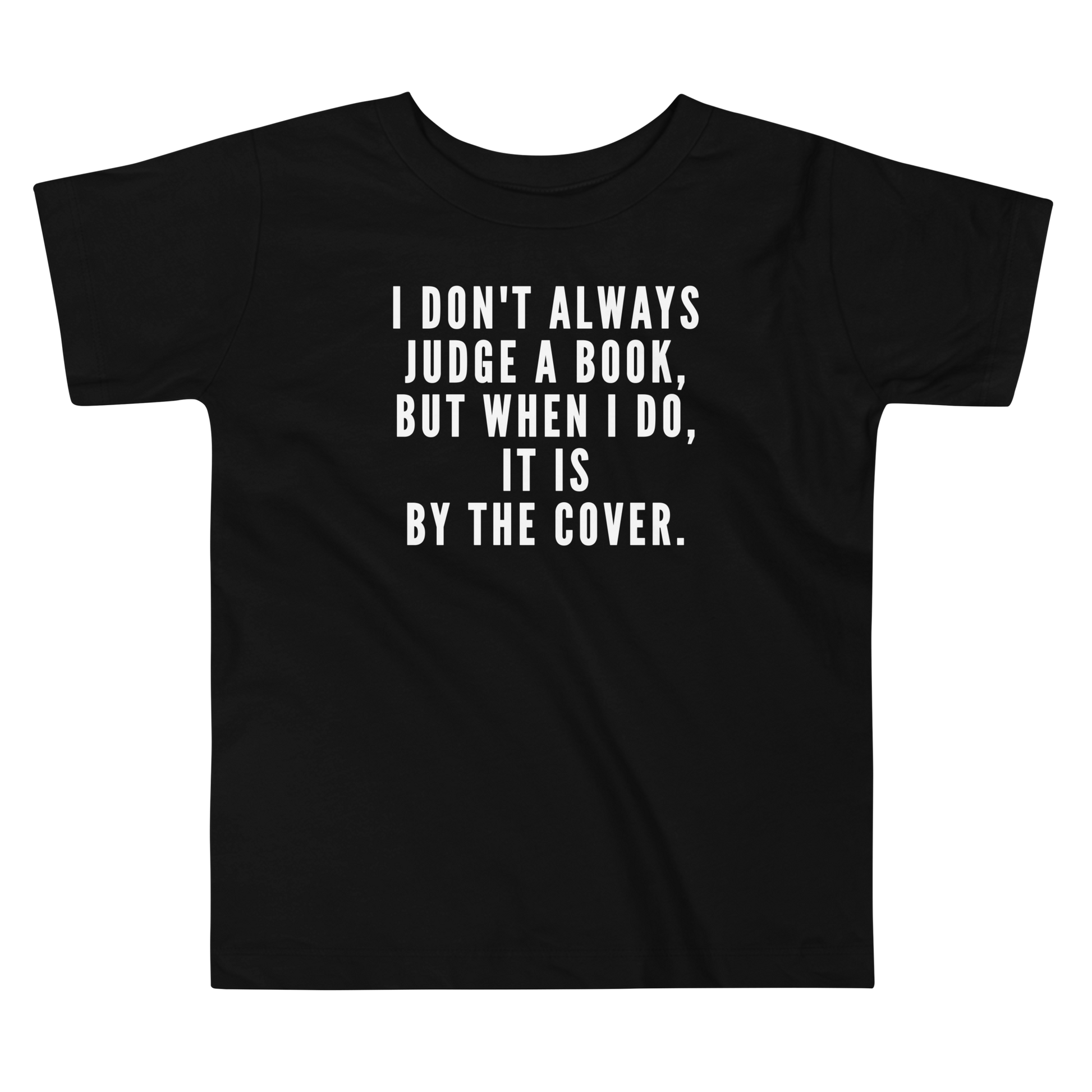 "I Don't always Judge a Book, but when I do, it's by the cover." printed on a black toddler short sleeve tee laying on a flat surface