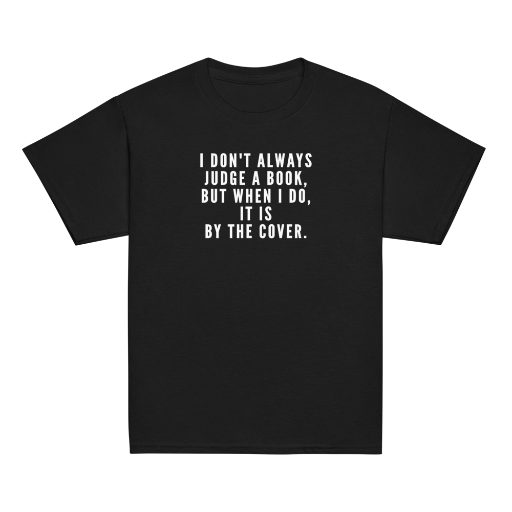 "I Don't always Judge a Book, but when I do, it's by the cover." printed on a black youth classic tee laying on a flat surface