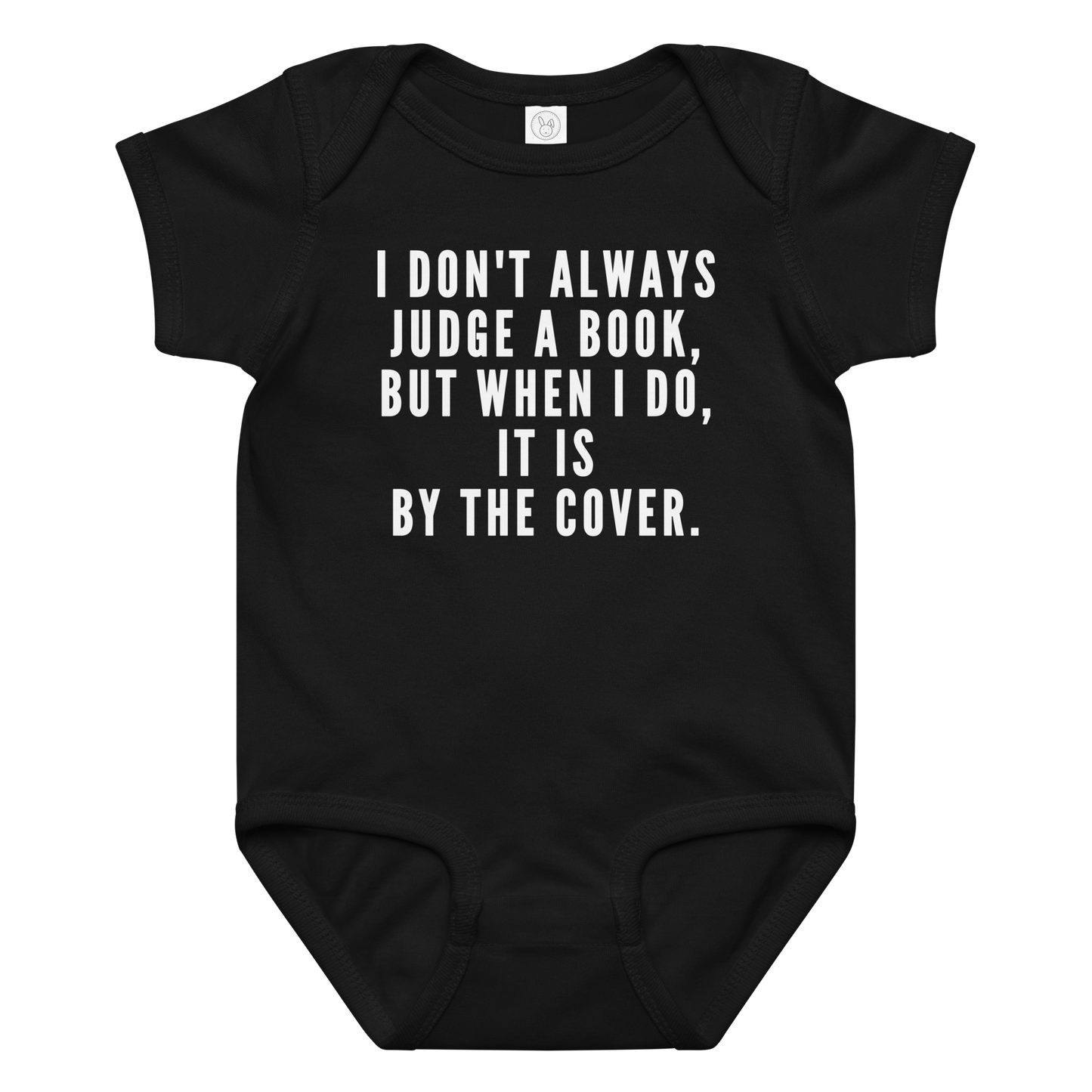 "I Don't always Judge a Book, but when I do, it's by the cover." printed on a black baby jersey bodysuit laying on a flat surface amongst other clothes