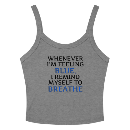 "Whenever I'm feeling blue, I remind myself to breathe" printed on a athletic heather women's micro-rib tanktop laying on a flat surface amongst sunglasses and shorts