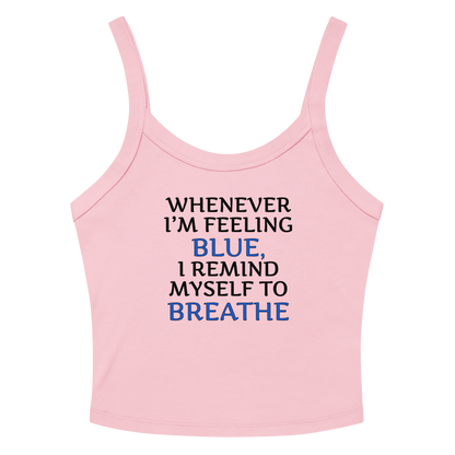 "Whenever I'm feeling blue, I remind myself to breathe" printed on a solid pink blend women's micro-rib tanktop laying on a flat surface amongst sunglasses and shorts