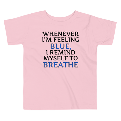 "Whenever I'm feeling blue, I remind myself to breathe" printed on a pink toddler short sleeve tee laying on a flat surface