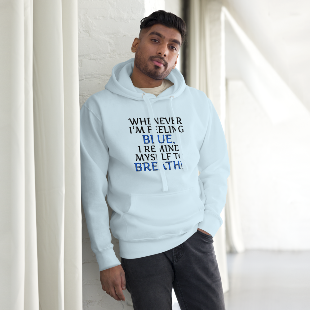 "Whenever I'm feeling blue, I remind myself to breathe" printed on a sky blue unisex hoodie worn by a male