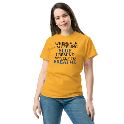 "Whenever I'm feeling blue, I remind myself to breathe" printed on a gold unisex classic tee worn by a female