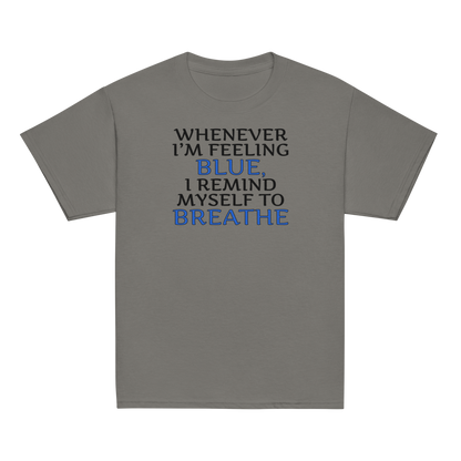 "Whenever I'm feeling blue, I remind myself to breathe" printed on a charcoal youth classic tee laying on a flat surface