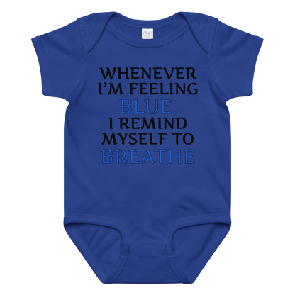 "Whenever I'm feeling blue, I remind myself to breathe" printed on a royal baby jersey bodysuit laying on a flat surface amongst other clothes