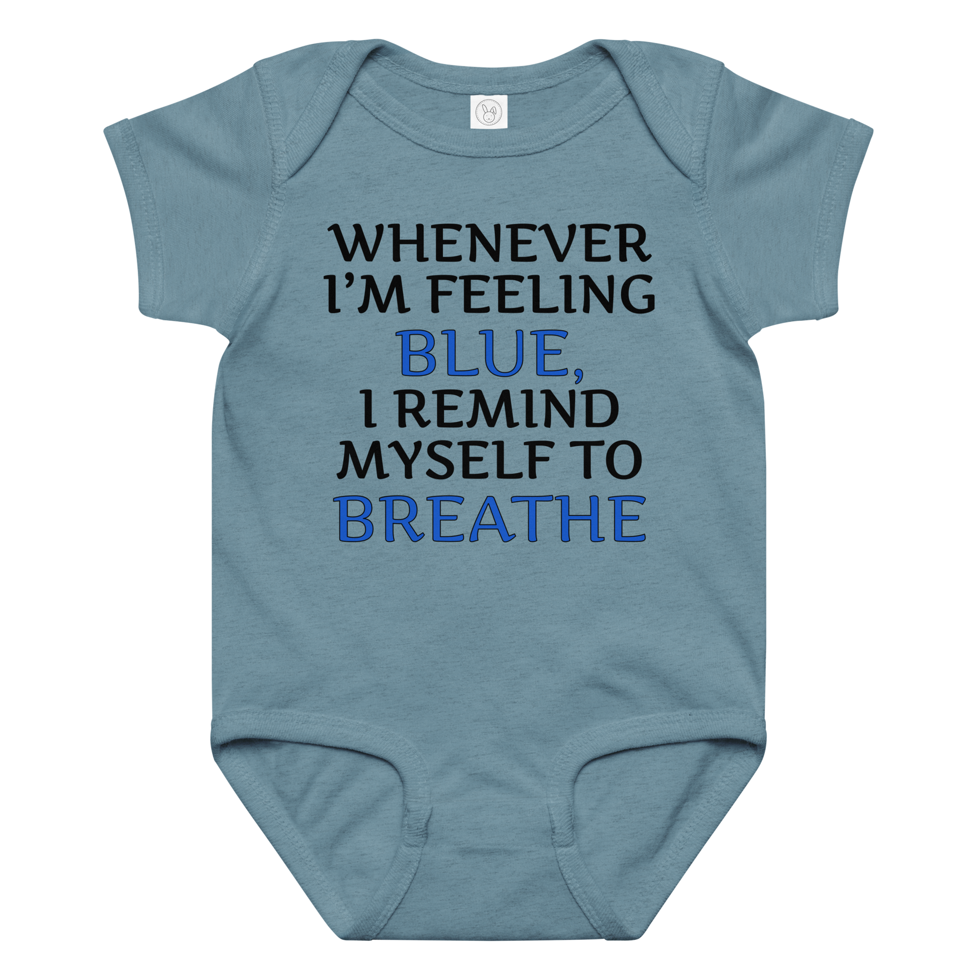 "Whenever I'm feeling blue, I remind myself to breathe" printed on a vintage indigo baby jersey bodysuit laying on a flat surface amongst other clothes