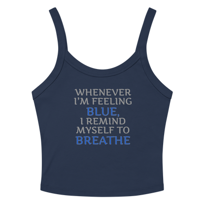 "Whenever I'm feeling blue, I remind myself to breathe" printed on a solid navy blend women's micro-rib tanktop laying on a flat surface amongst sunglasses and shorts