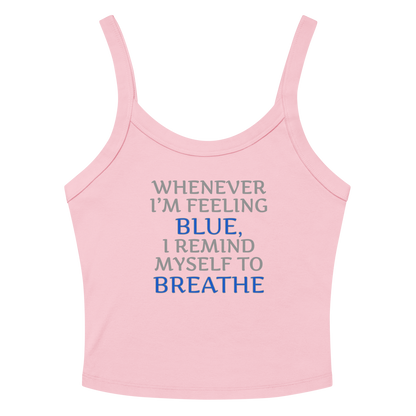 "Whenever I'm feeling blue, I remind myself to breathe" printed on a solid pink blend women's micro-rib tanktop laying on a flat surface amongst sunglasses and shorts