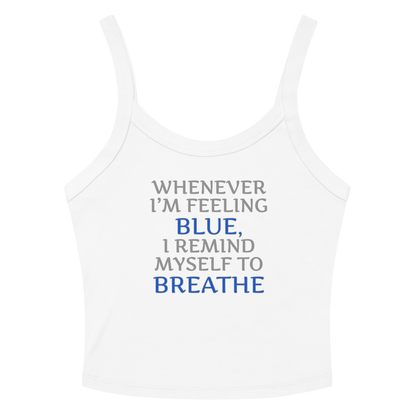 "Whenever I'm feeling blue, I remind myself to breathe" printed on a solid white blend women's micro-rib tanktop laying on a flat surface amongst sunglasses and shorts