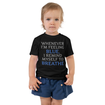 "Whenever I'm feeling blue, I remind myself to breathe" printed on a black toddler short sleeve tee worn by a female