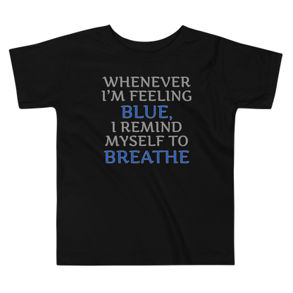 "Whenever I'm feeling blue, I remind myself to breathe" printed on a black toddler short sleeve tee laying on a flat surface