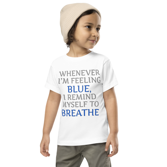 "Whenever I'm feeling blue, I remind myself to breathe" printed on a white toddler short sleeve tee worn by a male wearing a cap
