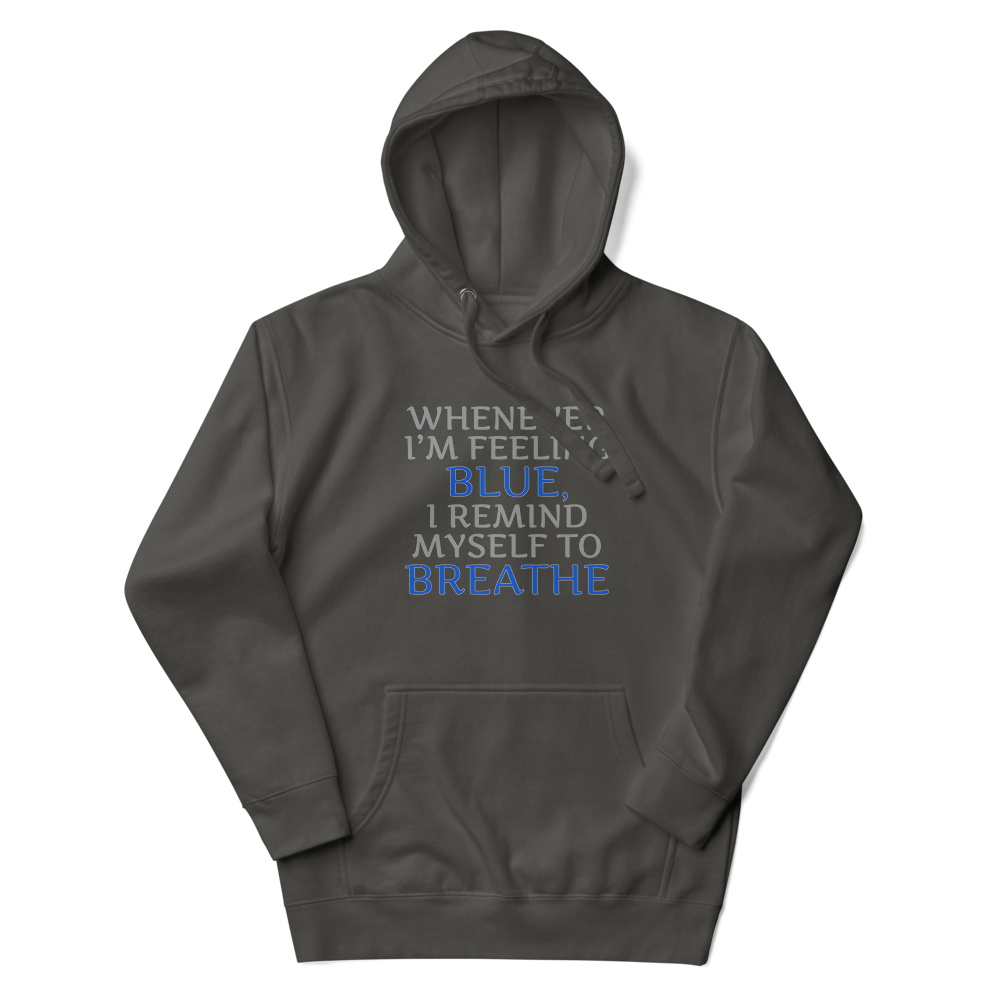 "Whenever I'm feeling blue, I remind myself to breathe" printed on a vintage black unisex hoodie laying on a flat surface with the hood up