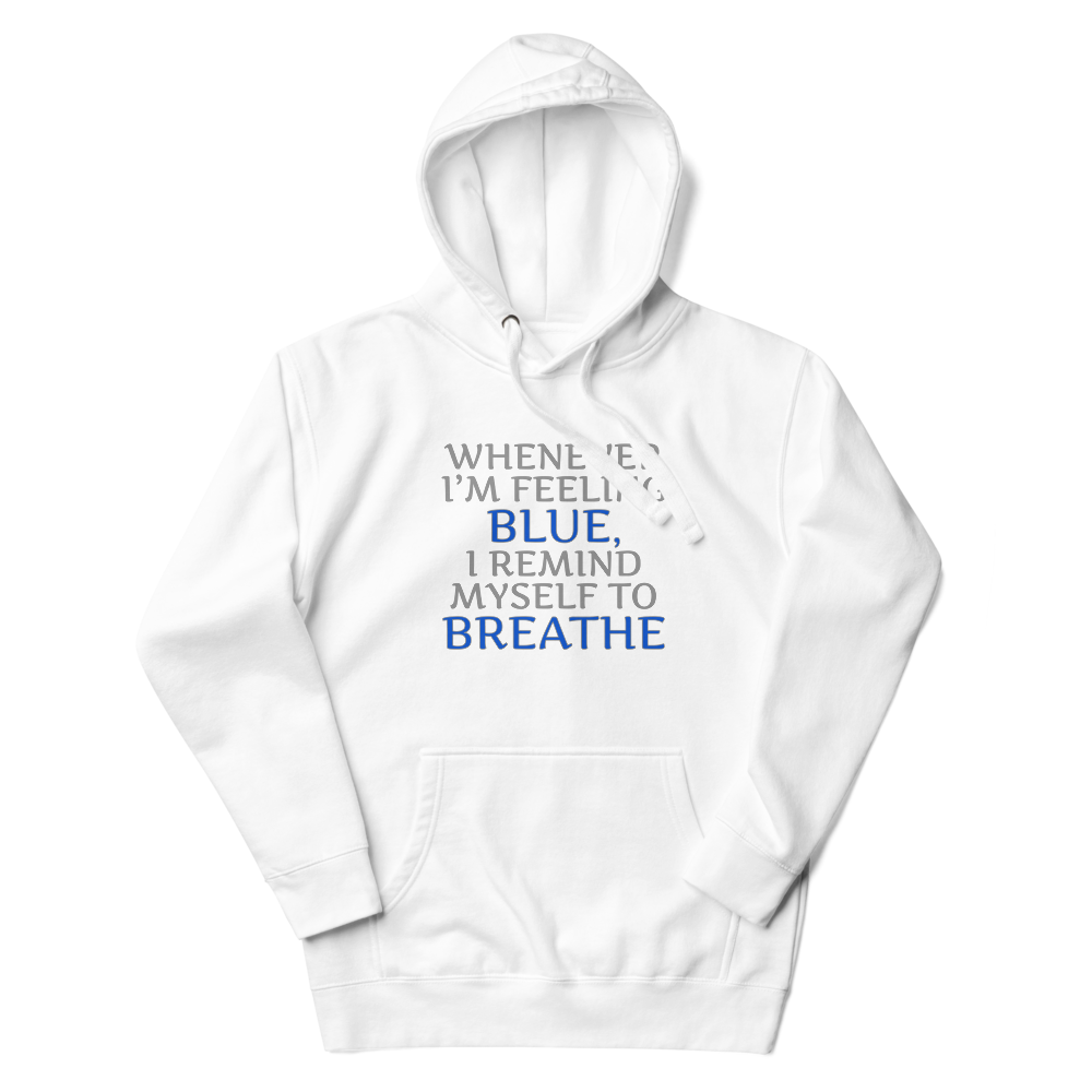 "Whenever I'm feeling blue, I remind myself to breathe" printed on a white unisex hoodie laying on a flat surface with the hood up