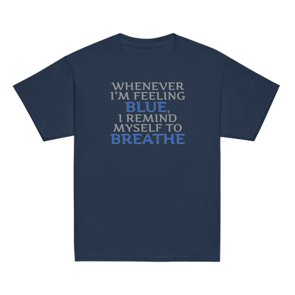 "Whenever I'm feeling blue, I remind myself to breathe" printed on a navy youth classic tee laying on a flat surface